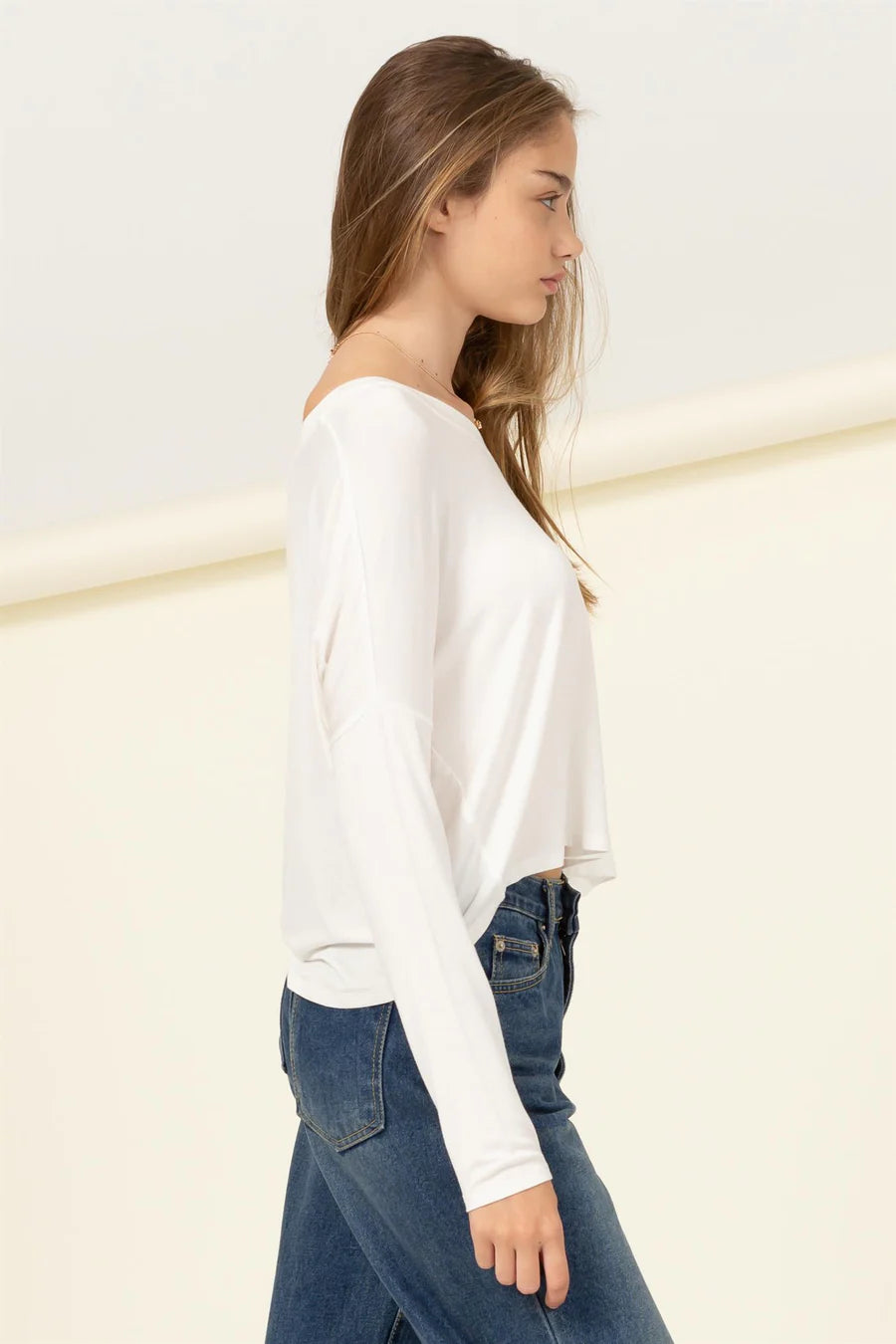 The model is wearing an Off White Love Me Right V Neck Loose Fit Top and jeans by HYFVE.