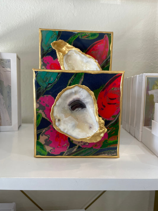 Two 6x6 - Glazed Oyster on Printed Canvas shells on top of a shelf. (Brand: Bella Gifts To Geaux)