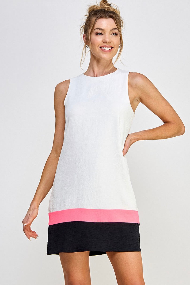 A woman wearing the Caramela Airflow Dress | White and pink sleeveless dress.