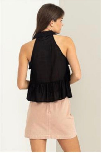 The back view of a woman wearing a HYFVE Summer Dreams Button-Front Ruffled top and pink skirt.
