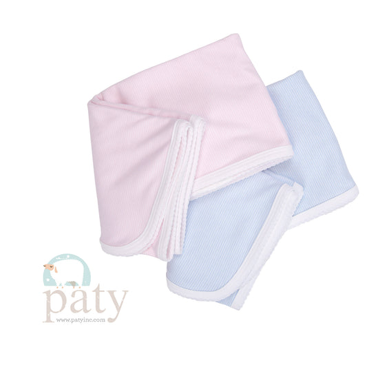 A pair of Paty baby bibs sitting on top of each other.