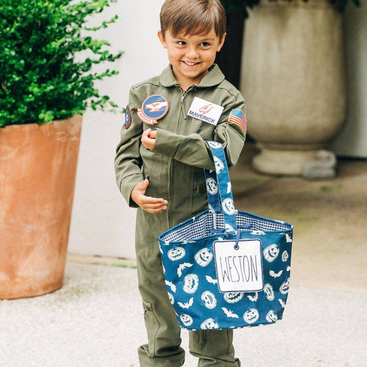 A boy in a space suit holding a Halloween Kids Basket - Vintage Halloween bag from Sugar Bee Clothing.
