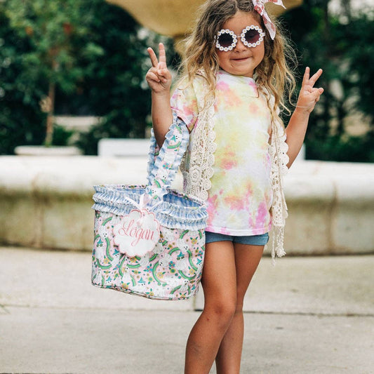 A little girl wearing sunglasses and a tie dye Halloween Basket - Hippie Halloween tote bag by Sugar Bee Clothing.