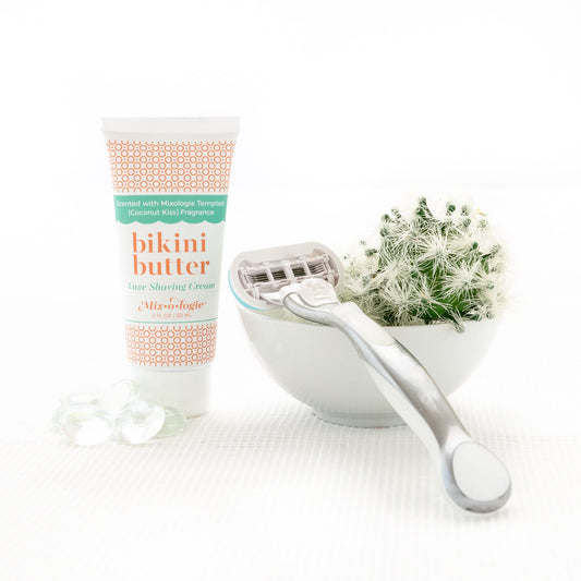 a bowl of flowers next to a tube of Mixologie's Bikini Butter.