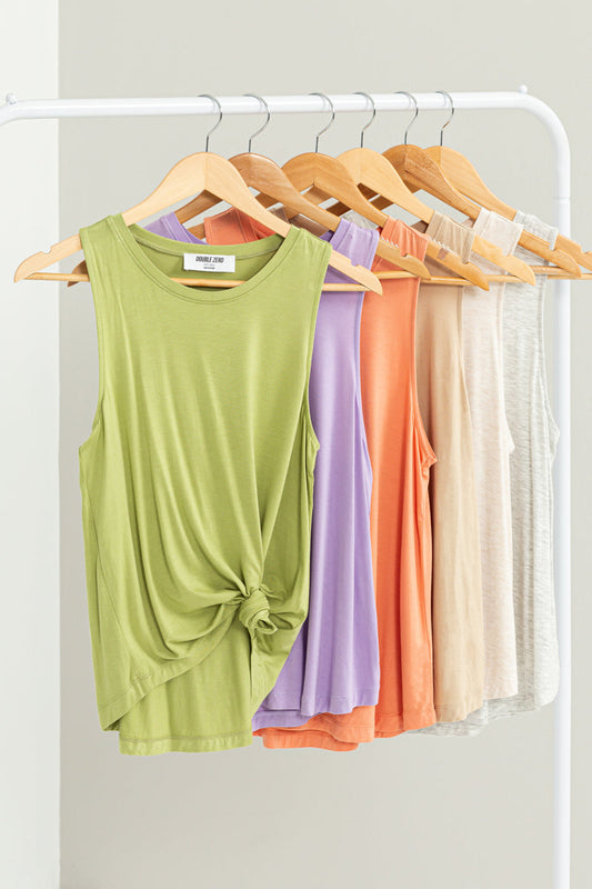 A group of colorful HYFVE sleeveless tank tops hanging on a rack.
