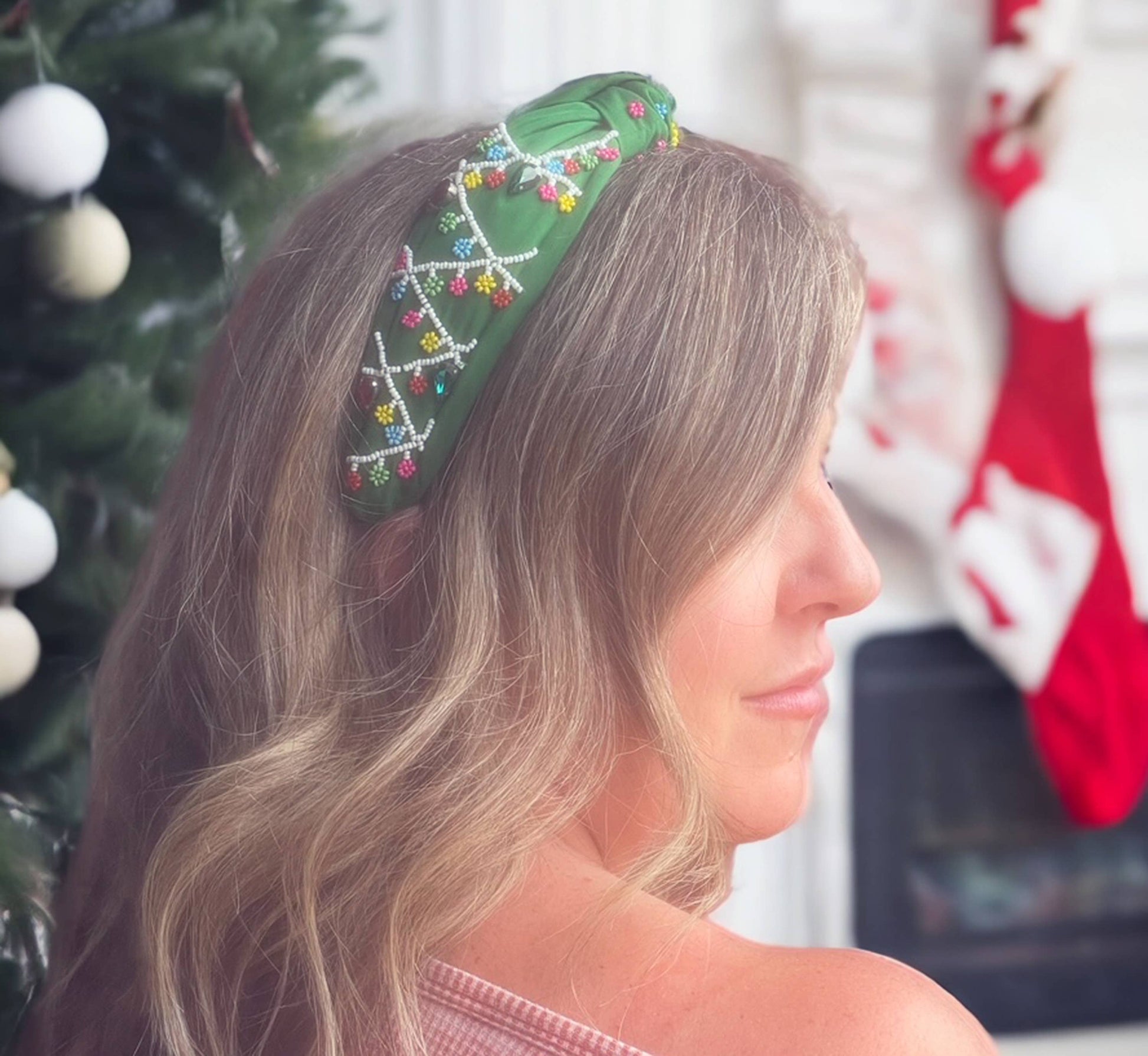 A Bash woman wearing a Festive Beaded Christmas Headband in front of a Christmas tree.