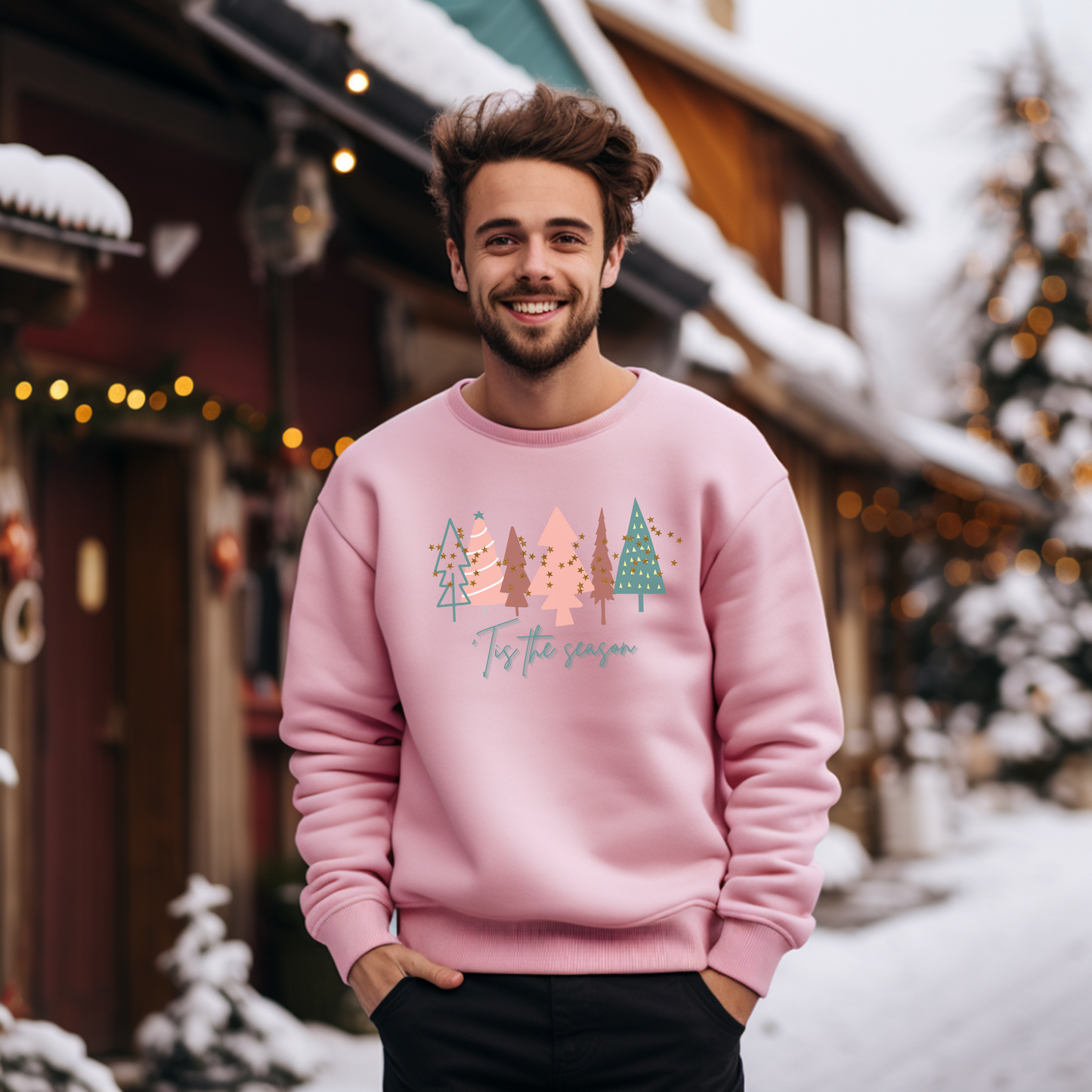 A man wearing a cozy Light Pink Christmas Tree Sweatshirt from Printify in the snow.