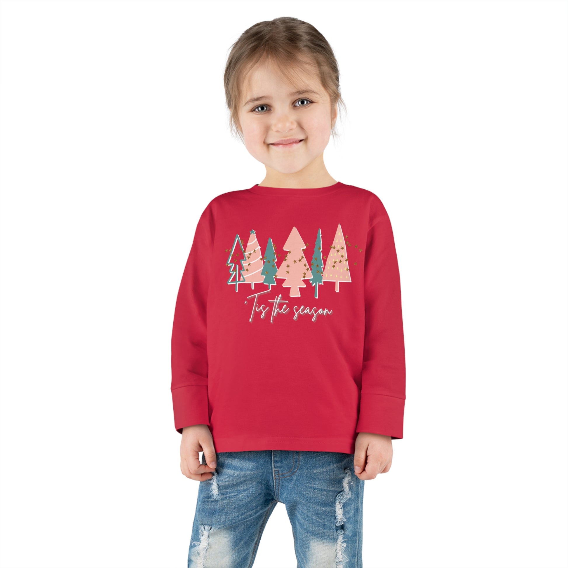 A toddler wearing a red Kids Christmas Tree long sleeve tee by Printify.