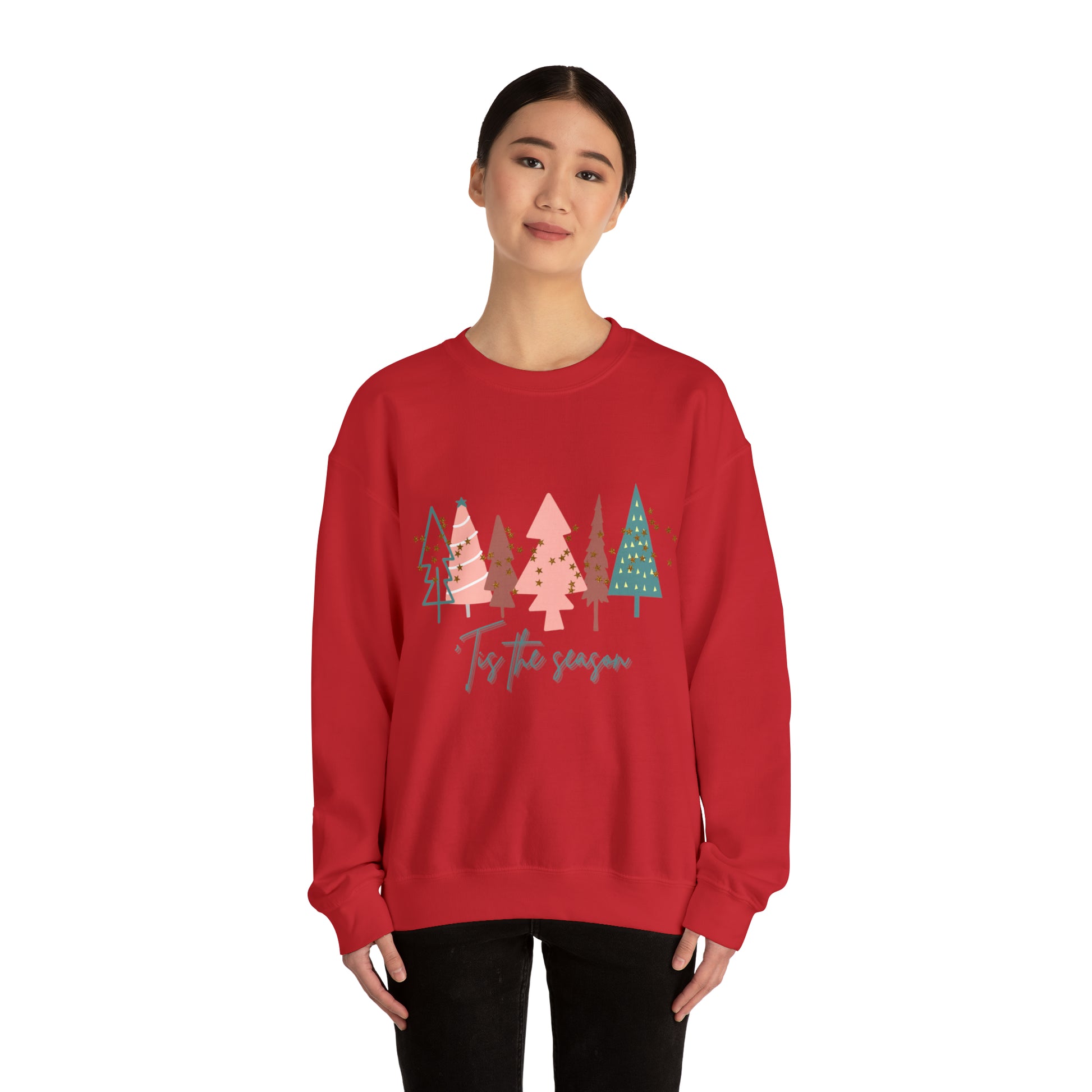 A cozy woman wearing a red Printify Christmas Tree Sweatshirt during winter.