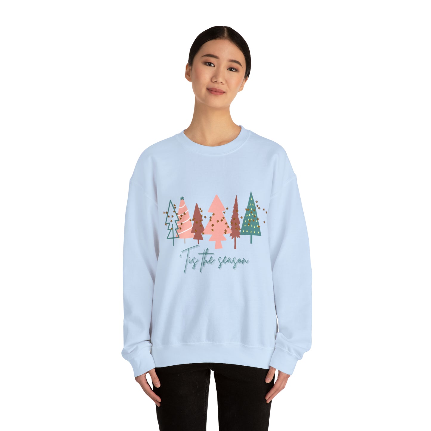 A woman wearing a warm and cozy Printify Christmas Tree Sweatshirt.
