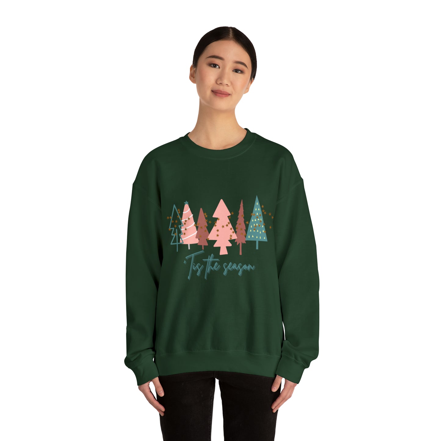 A cozy woman wearing a Printify Christmas Tree Sweatshirt adorned with Christmas trees.