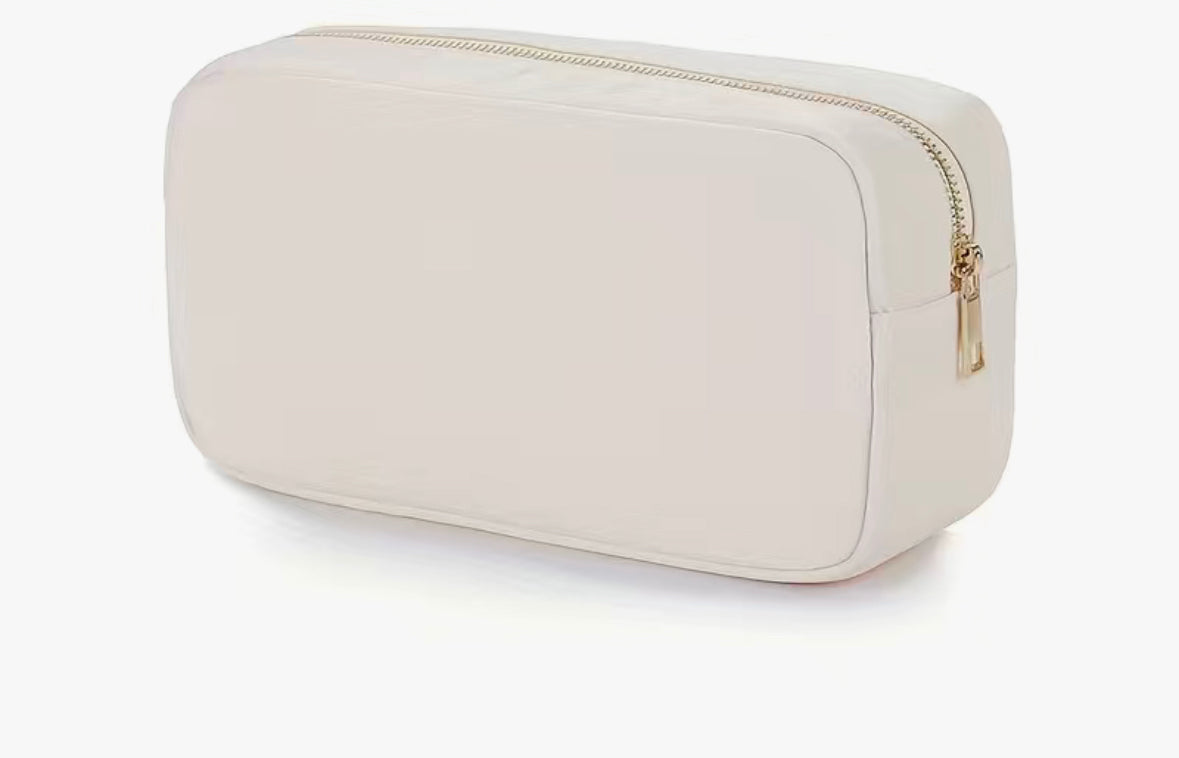 A compact and durable Chickie Collective Nylon Cosmetic Bag on a white surface.