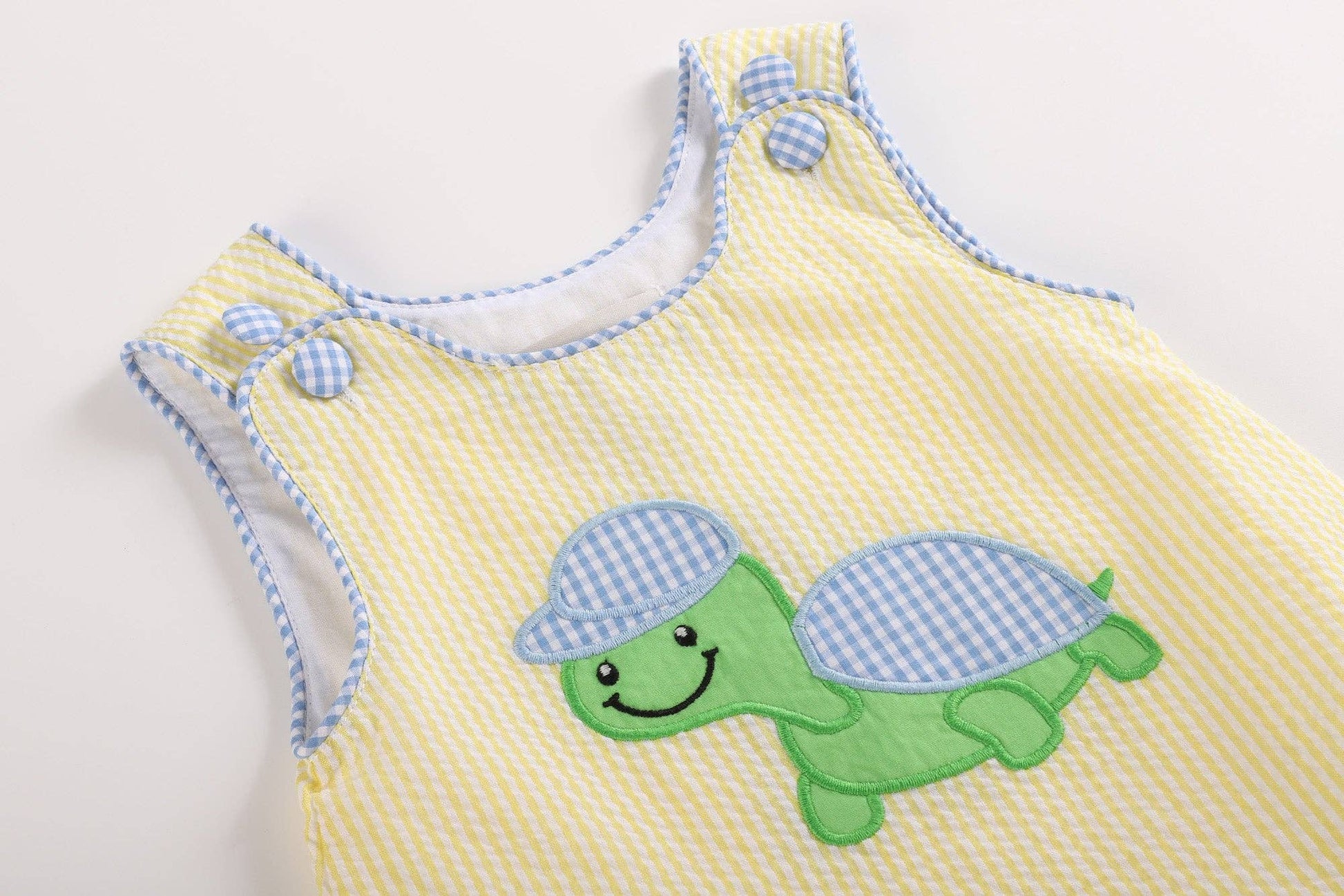 A cute Yellow Seersucker Turtle Baby Romper by Lil Cactus, perfect for summer.