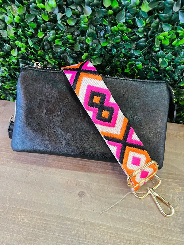 a black Kaydee Lynn wallet with a colorful aztec pattern on it.