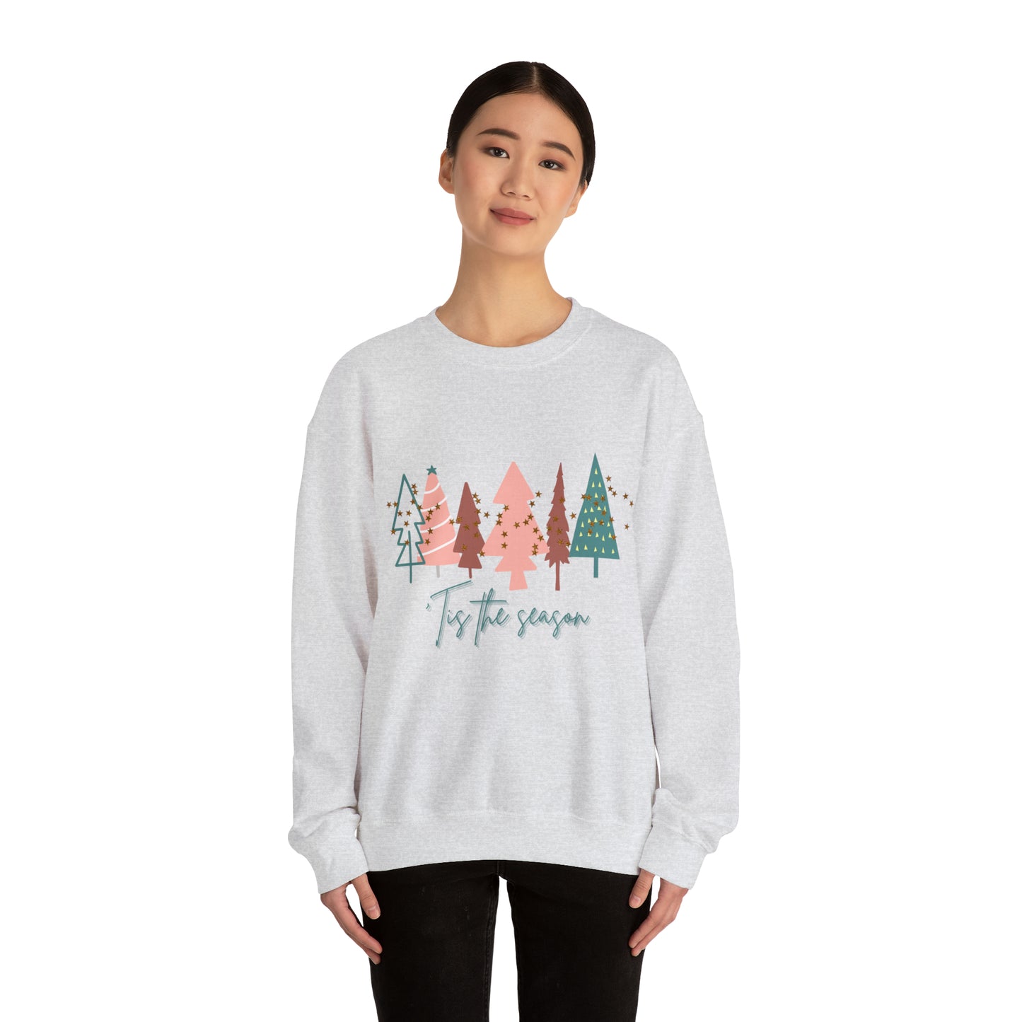 A cozy woman wearing a Printify Christmas Tree Sweatshirt during the winter months.