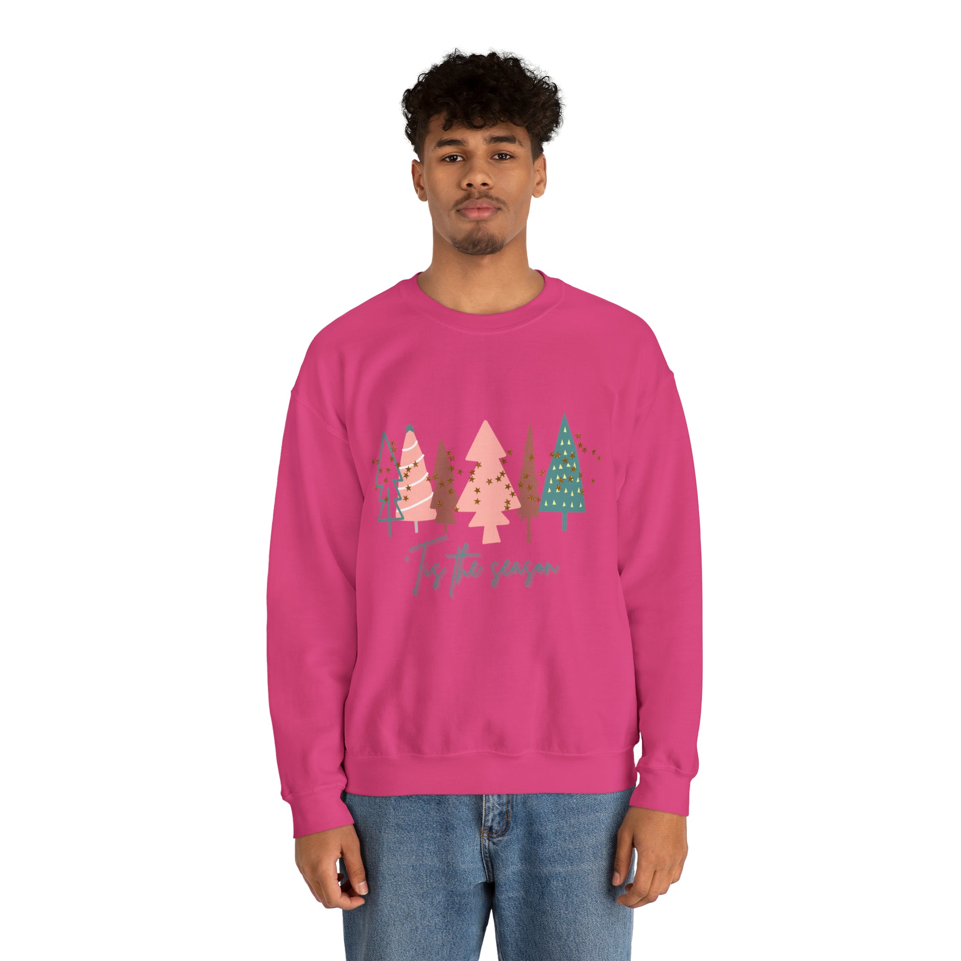 A man wearing a cozy pink Printify Christmas Tree Sweatshirt.