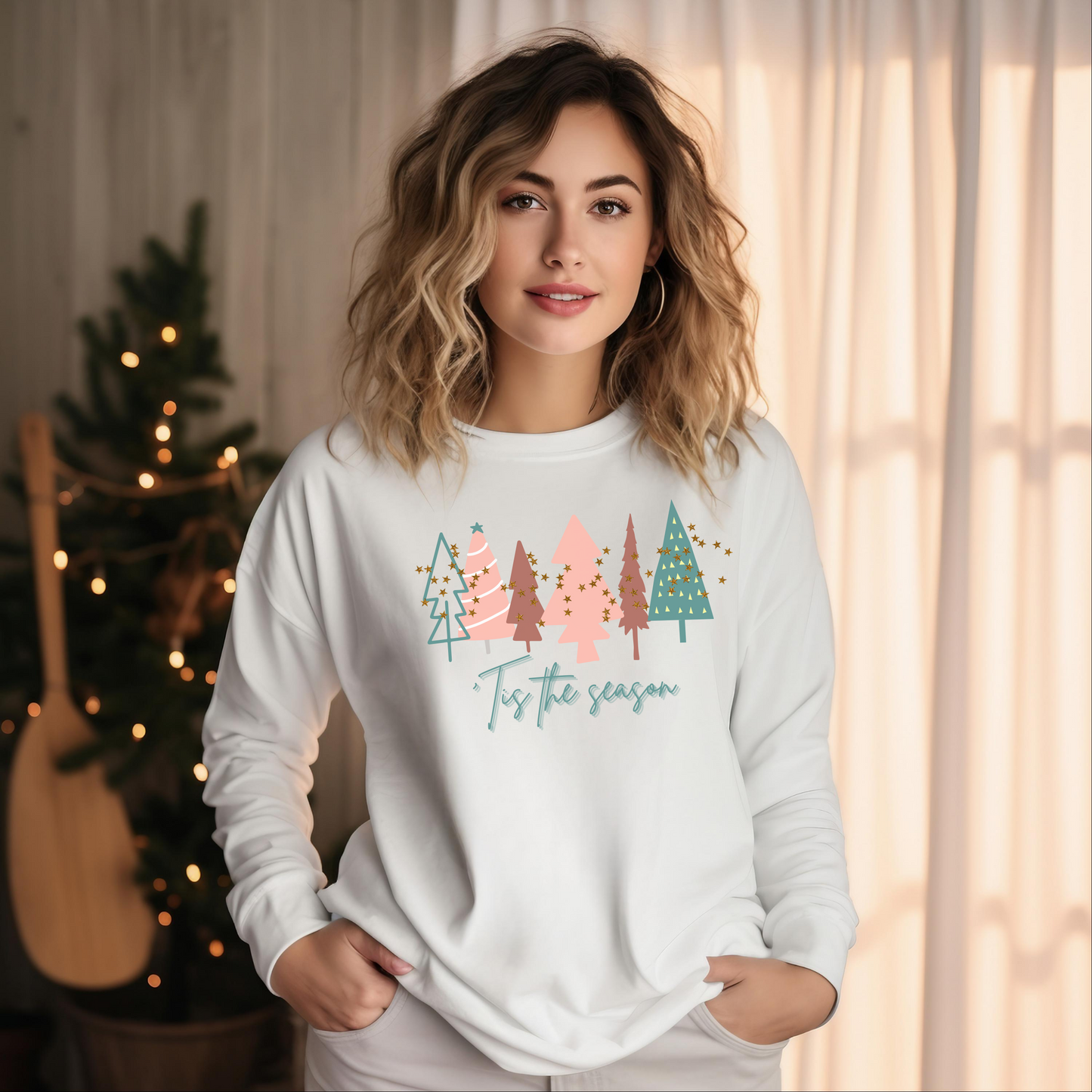 A woman wearing a cozy Printify 'Tis the Season White Christmas Tree Shirt | Comfort Colors Holiday Tee.