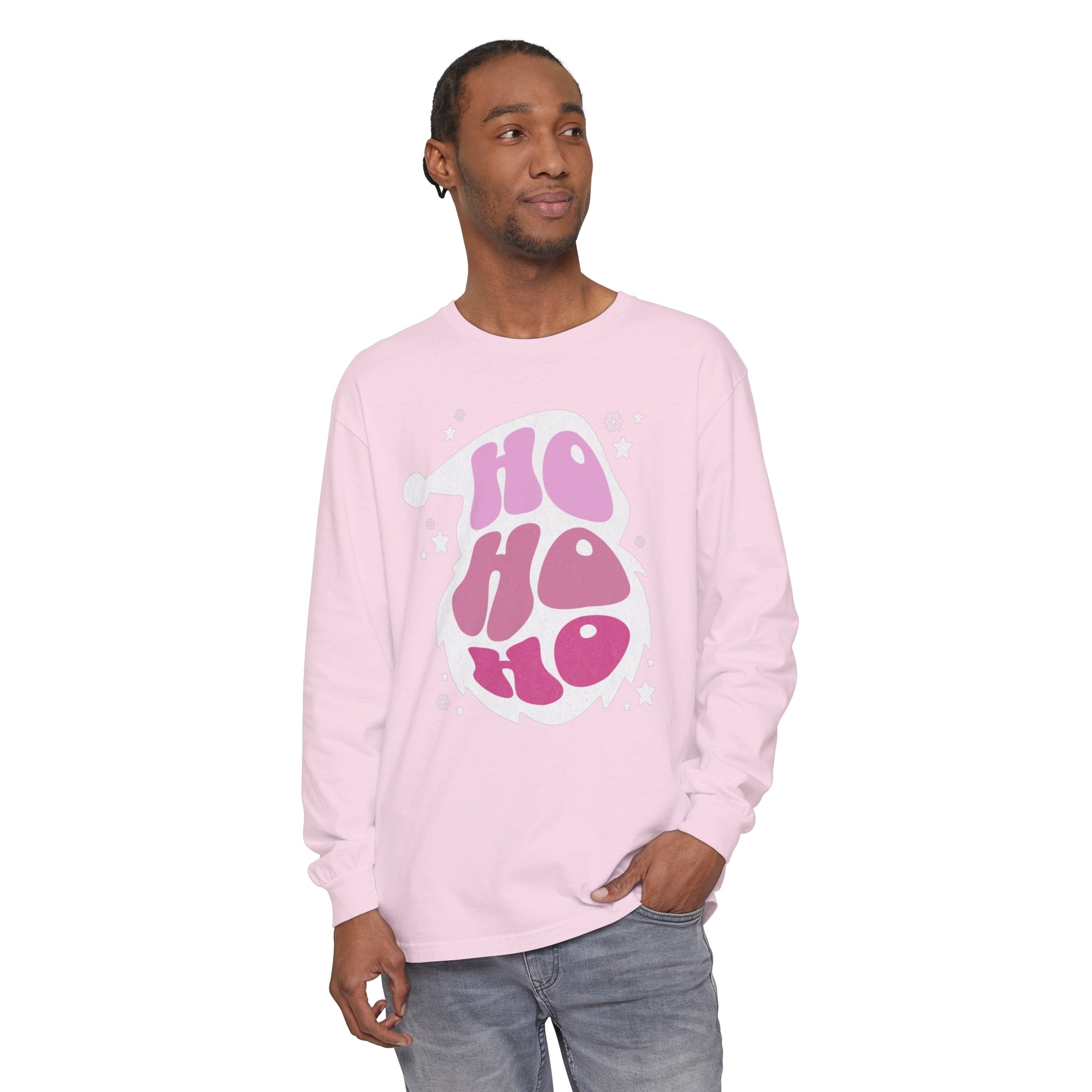 A man wearing a cozy pink long sleeve t-shirt with the word "HO HO HO Santa Outline" on it, perfect for holiday style.