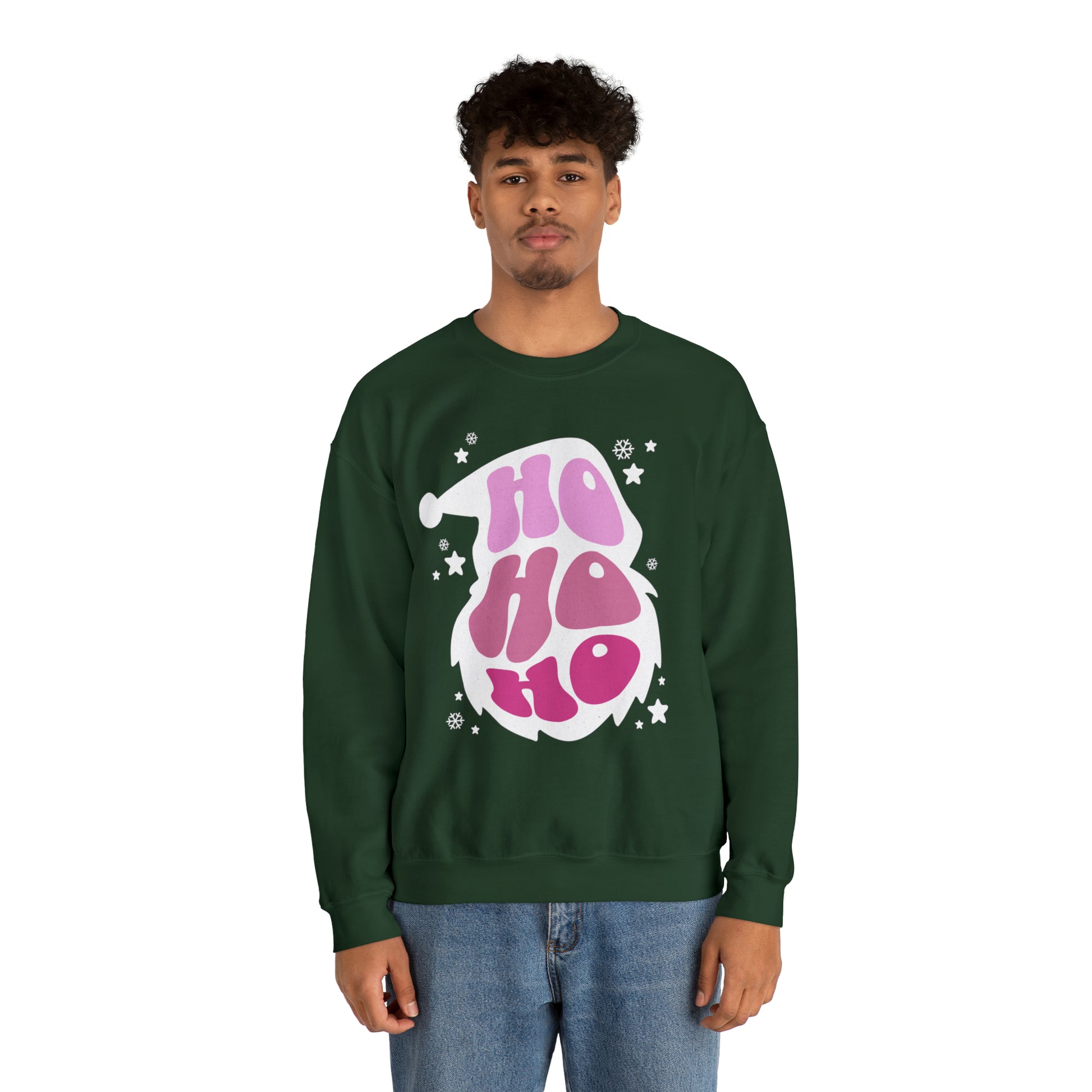 A man wearing a comfortable green sweatshirt with the Printify Ho Ho Ho Santa Outline Pink Holiday Sweatshirt - Cozy Crewneck - Festive Christmas Sweater on it, showcasing his unique style.