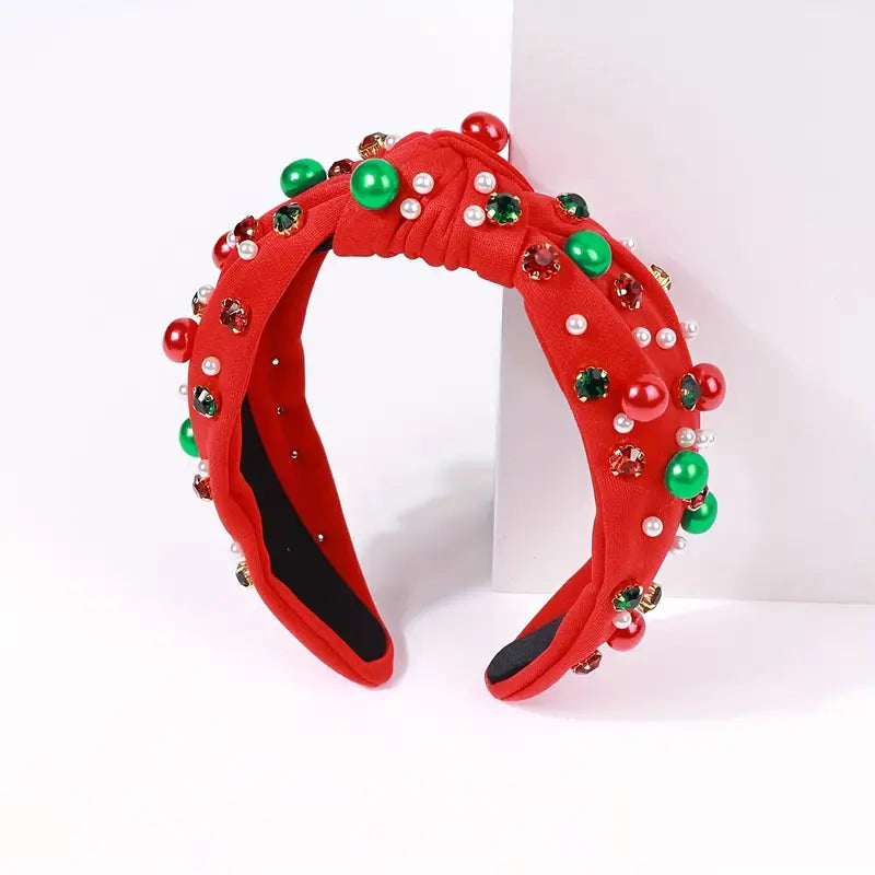 A Christmas Knotted Headband With Rhinestone Faux Pearls by Chickie Collective, with green and red beads.