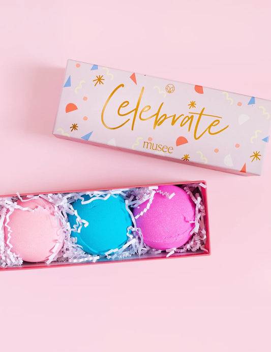 Two Musee "Celebrate Bath Bomb Trio" in a pink box, designed to nourish and relax.