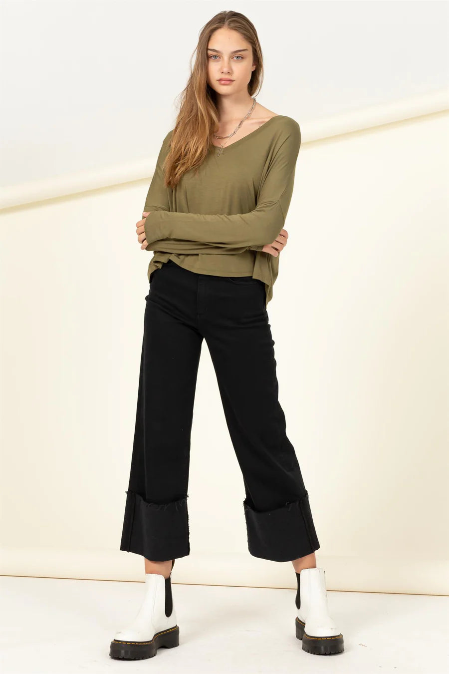 The model is wearing a Olive | Love Me Right V Neck Loose Fit Top by HYFVE and black pants.
