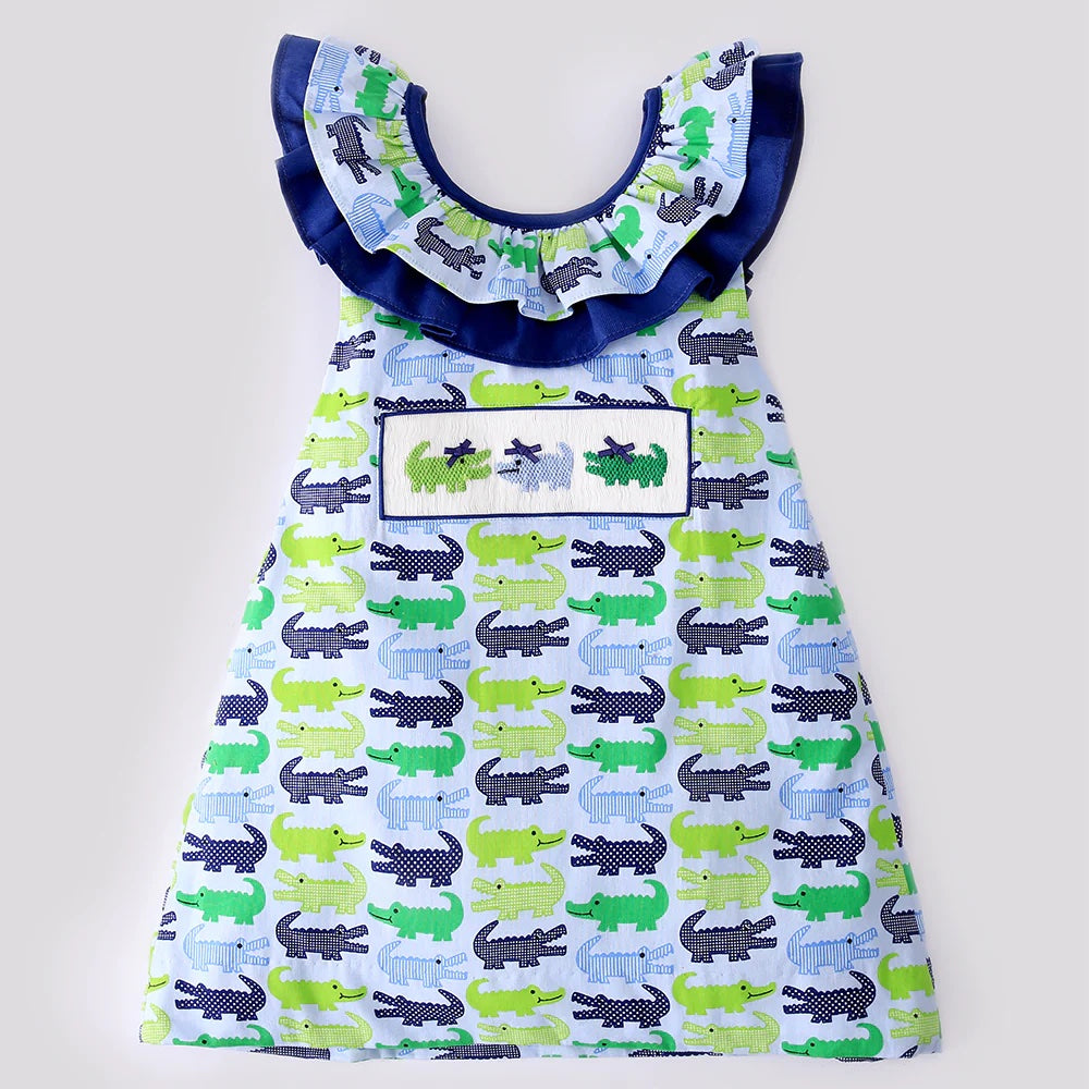 A Babeeni smocked alligator baby dress in blue and green.