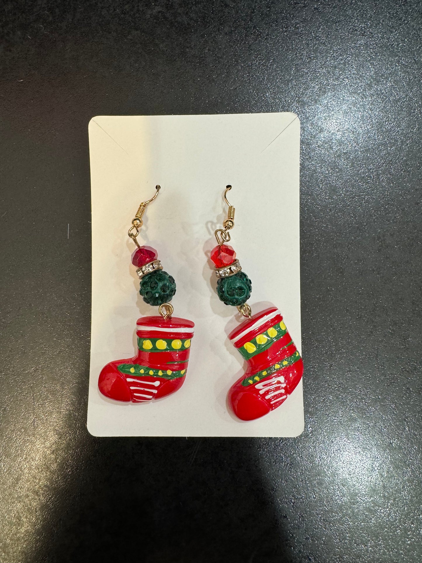 A pair of red and green Chickie Collective Stocking Earrings.