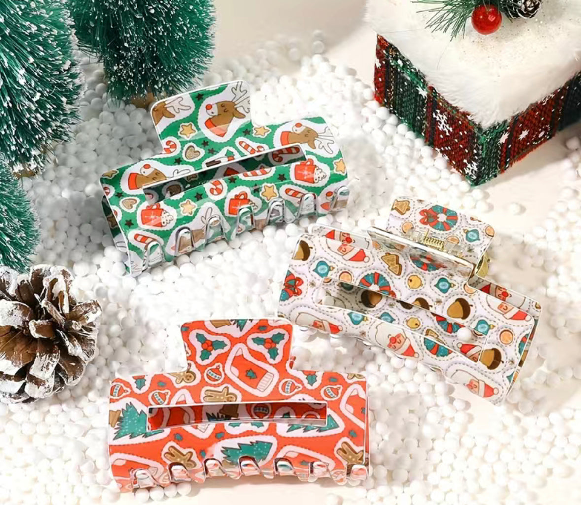 A set of Christmas Clips from Chickie Collective on a snowy surface, beautifully displaying holiday organization.