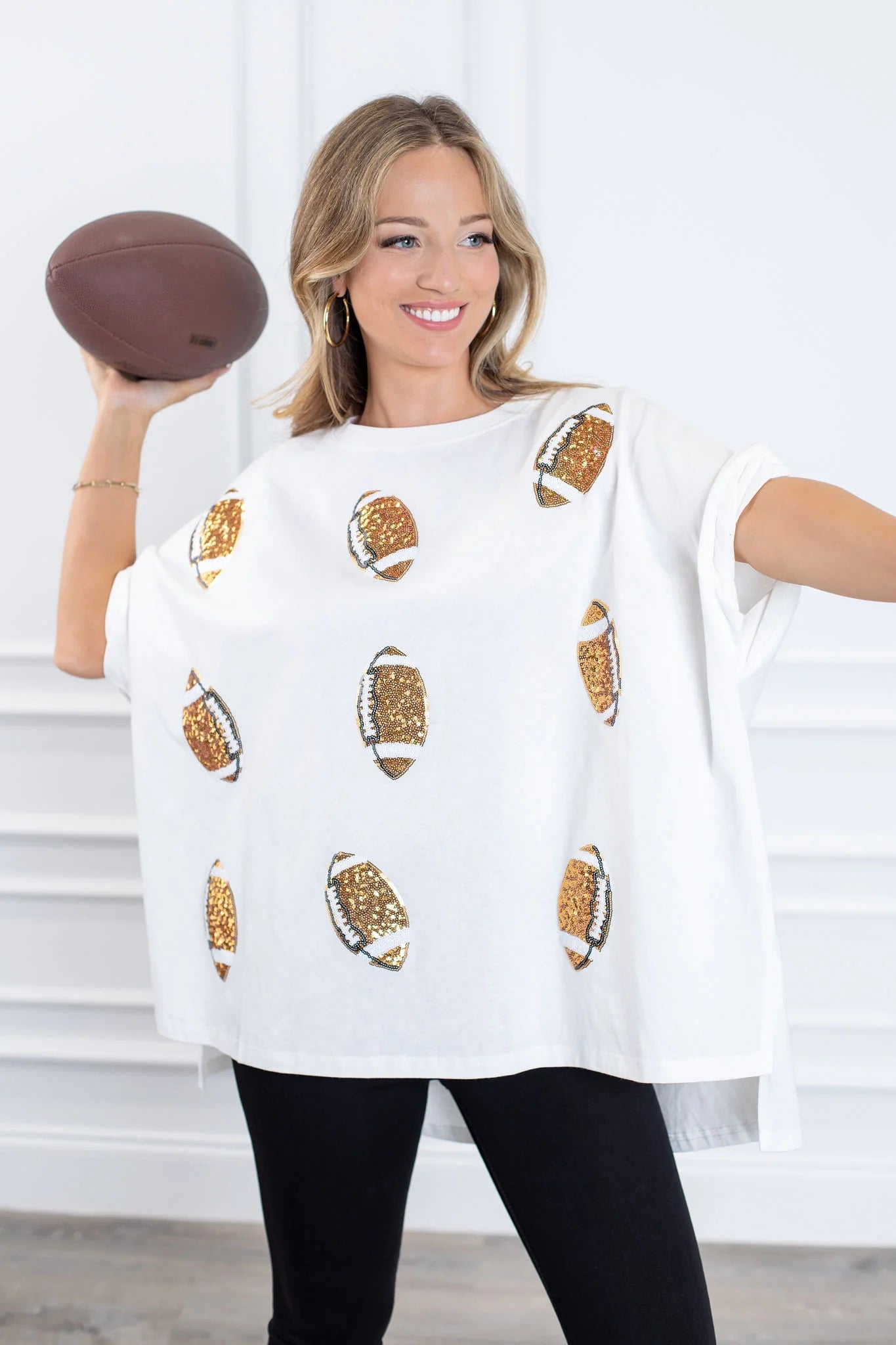 A woman wearing a Gold Football Short Sleeve Sequin Tee from Chickie Collective.