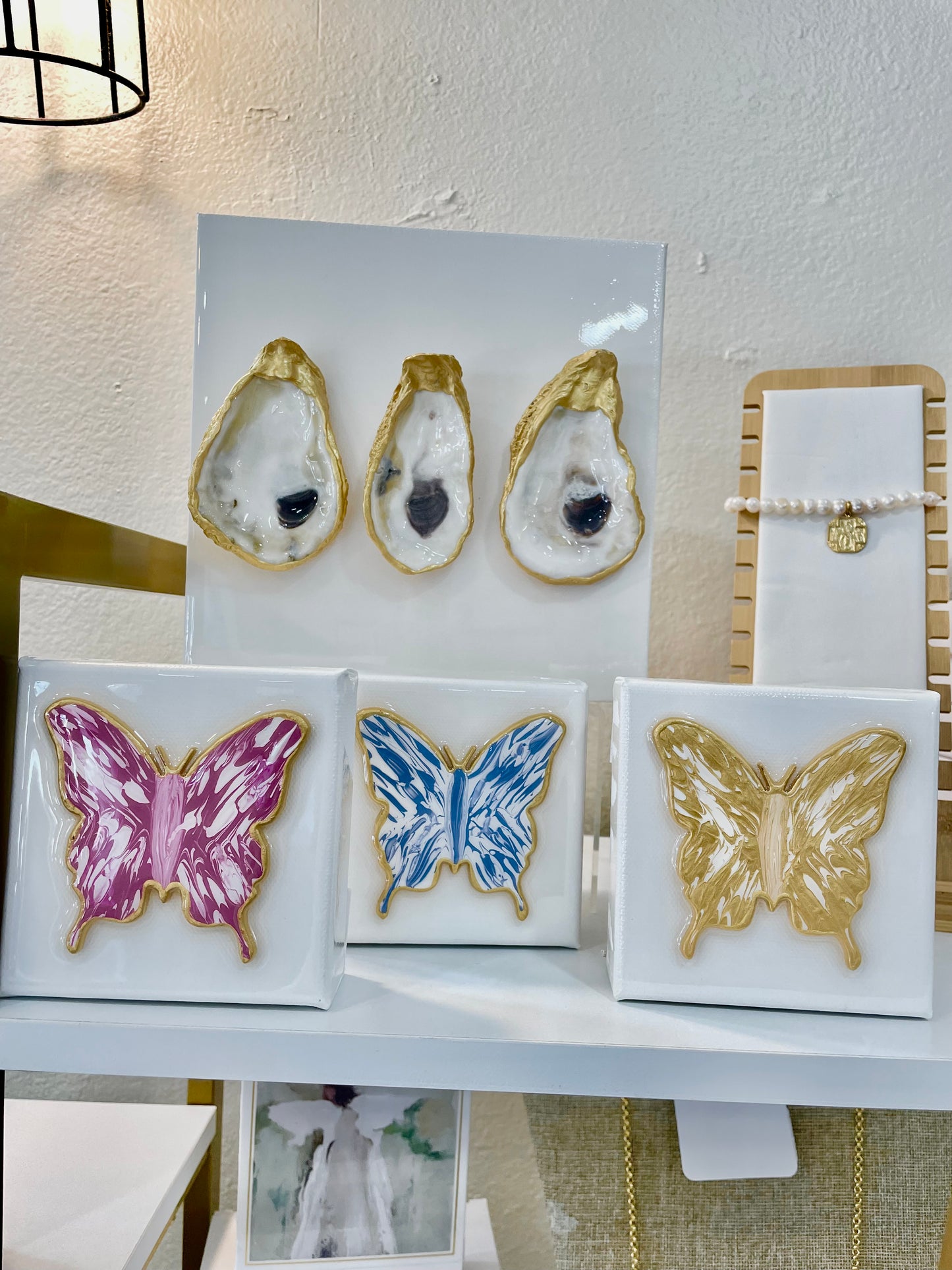 A display of Bella Gifts To Geaux's 4x4 - Butterfly - Blue/White on a shelf.