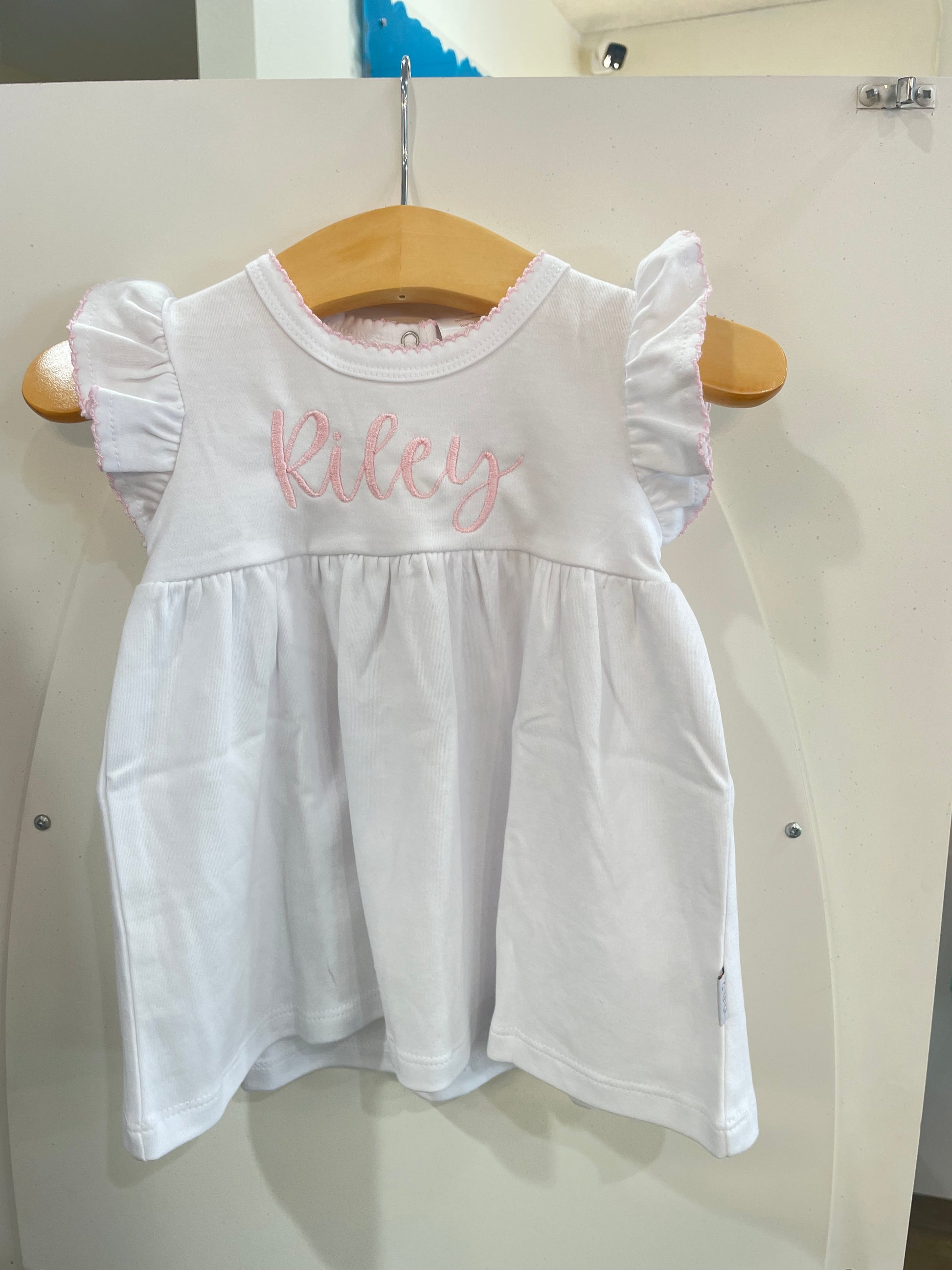 A Paty Ruffle Cotton Dress with a pink name on it.