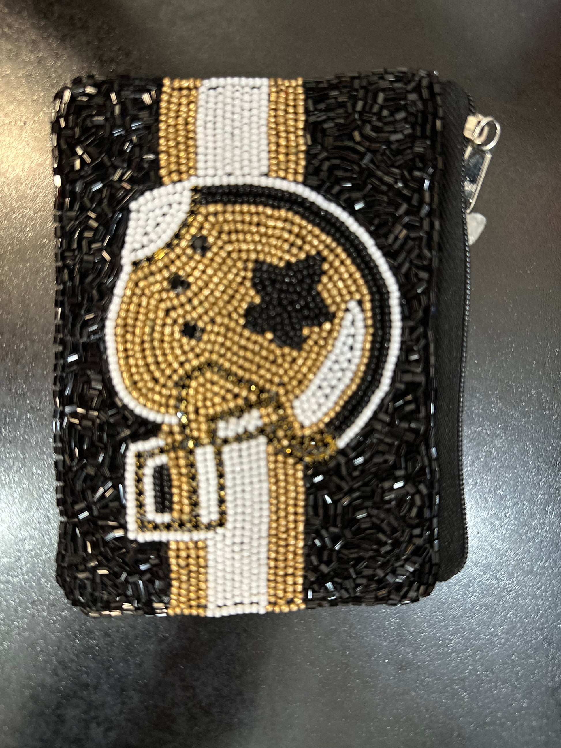 A black and gold Beaded Coin Purse - Saints Helmet with a football helmet on it by Misc Accessories.