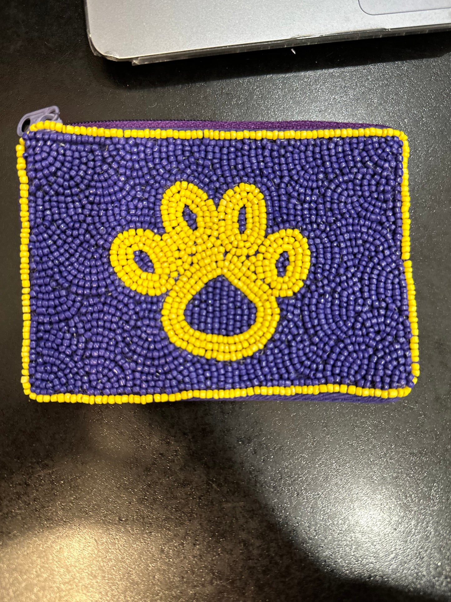a Beaded Coin Purse - Purple and Gold - Tiger Paw LSU with a paw print on it, by Chickie Collective.