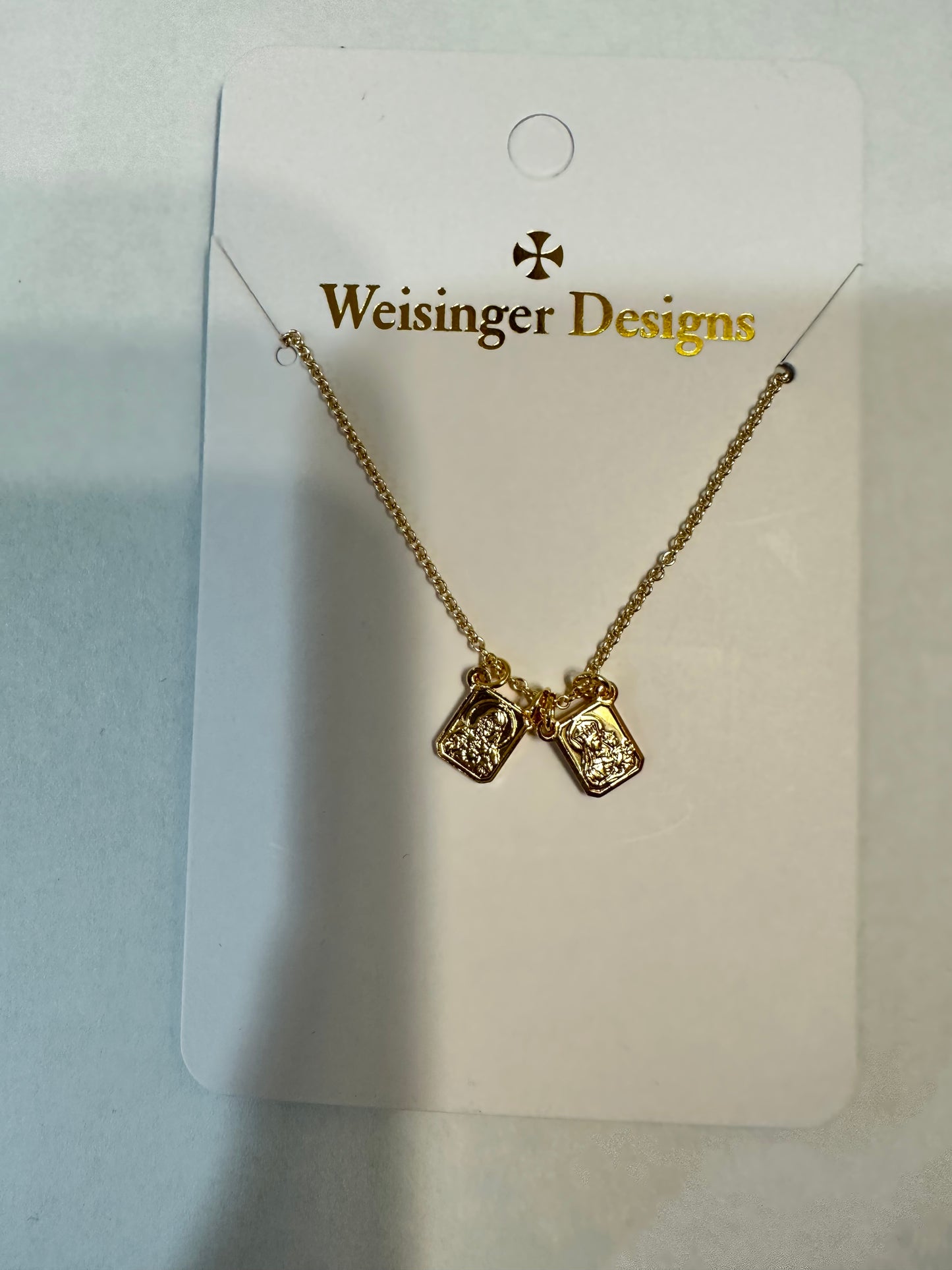 A Gold Filled Small Scapular Necklace with two small charms, symbolizing spiritual protection and guidance from Weisinger Designs.