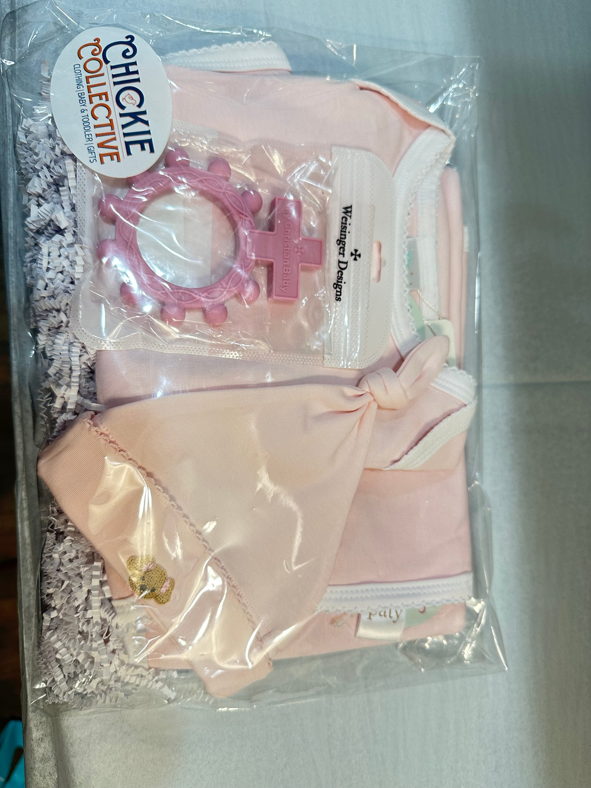 A Chickie Collective Baby Girl Bundle gift set with a pacifier and teether.