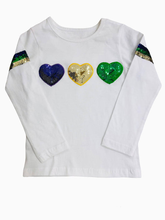 A Sequin Heart Long Sleeve Mardi Gras Shirt by Lulu Bebe with three sequin hearts sewn on it.