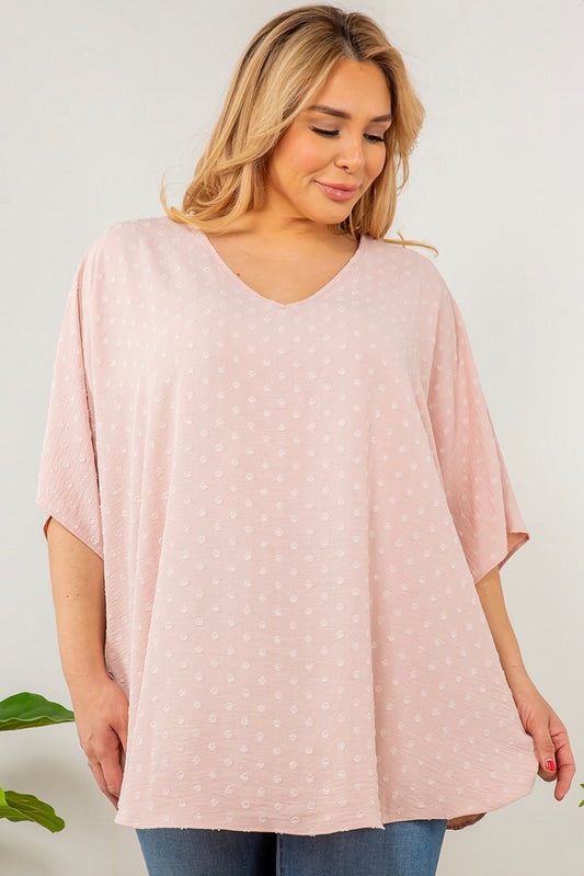 A woman wearing a Spin USA Oversized Dot V Neck Top in pink with white polka dots.