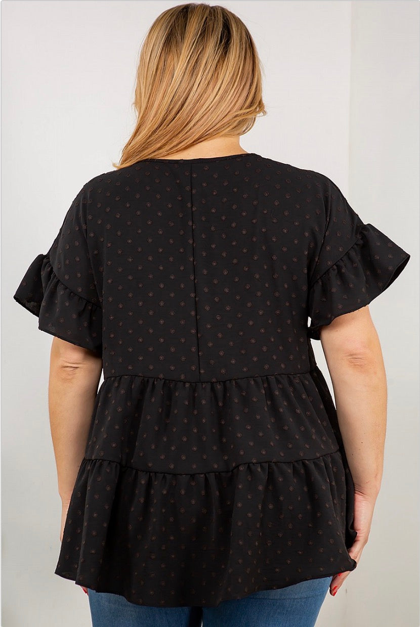 A woman wearing a Spin USA Dot Ruffle Sleeve, Multi Tier Tunic Top with brown polka dots.