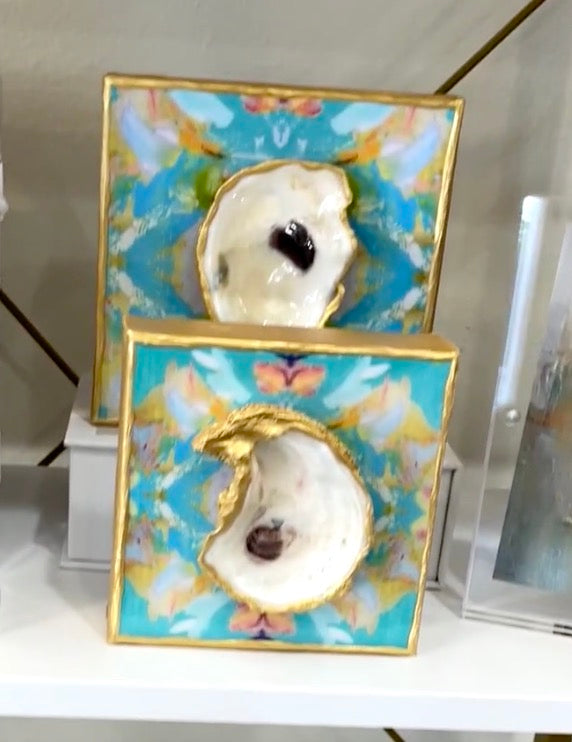 A display of Bella Gifts To Geaux's 4x4 - Glazed Oyster on Printed Canvas shells on a shelf.