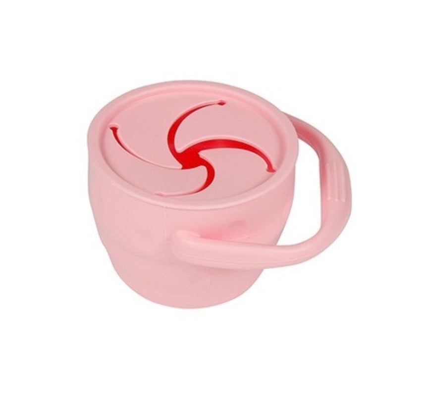 A pink Maison Chic Silicone Snack Cup with a handle and lid, dishwasher and microwave safe.