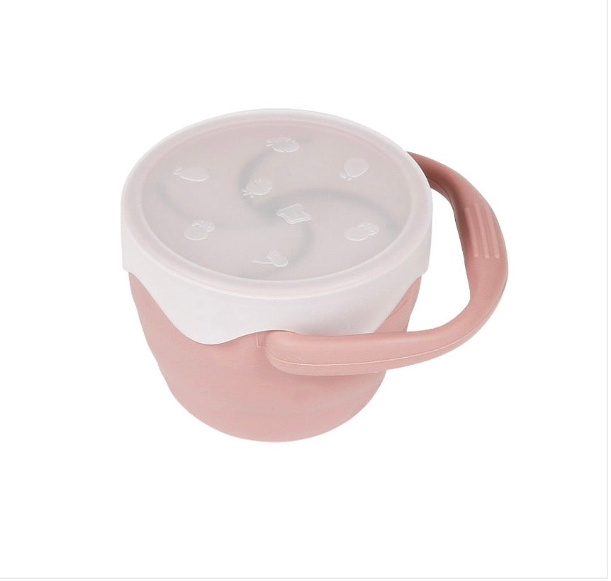 A pink and white Silicone Snack Cup w/ Lid with a handle and dishwasher safe from Maison Chic.