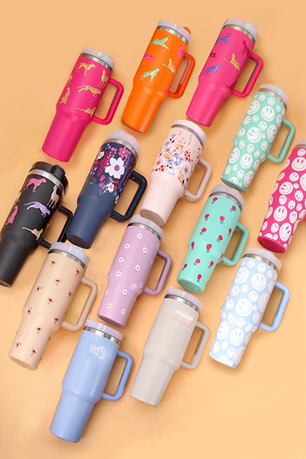 A group of colorful Wall To Wall Accessories stainless steel travel mugs with designs on them.