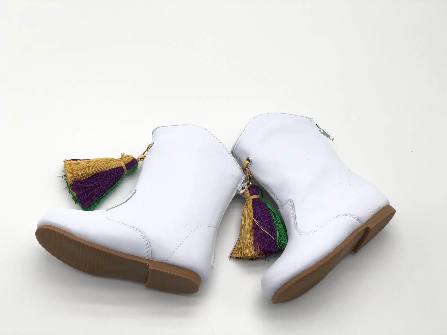 A pair of Infant & Kids Mardi Gras Boots by SeersuckerJOEY LLC with tassels on them.