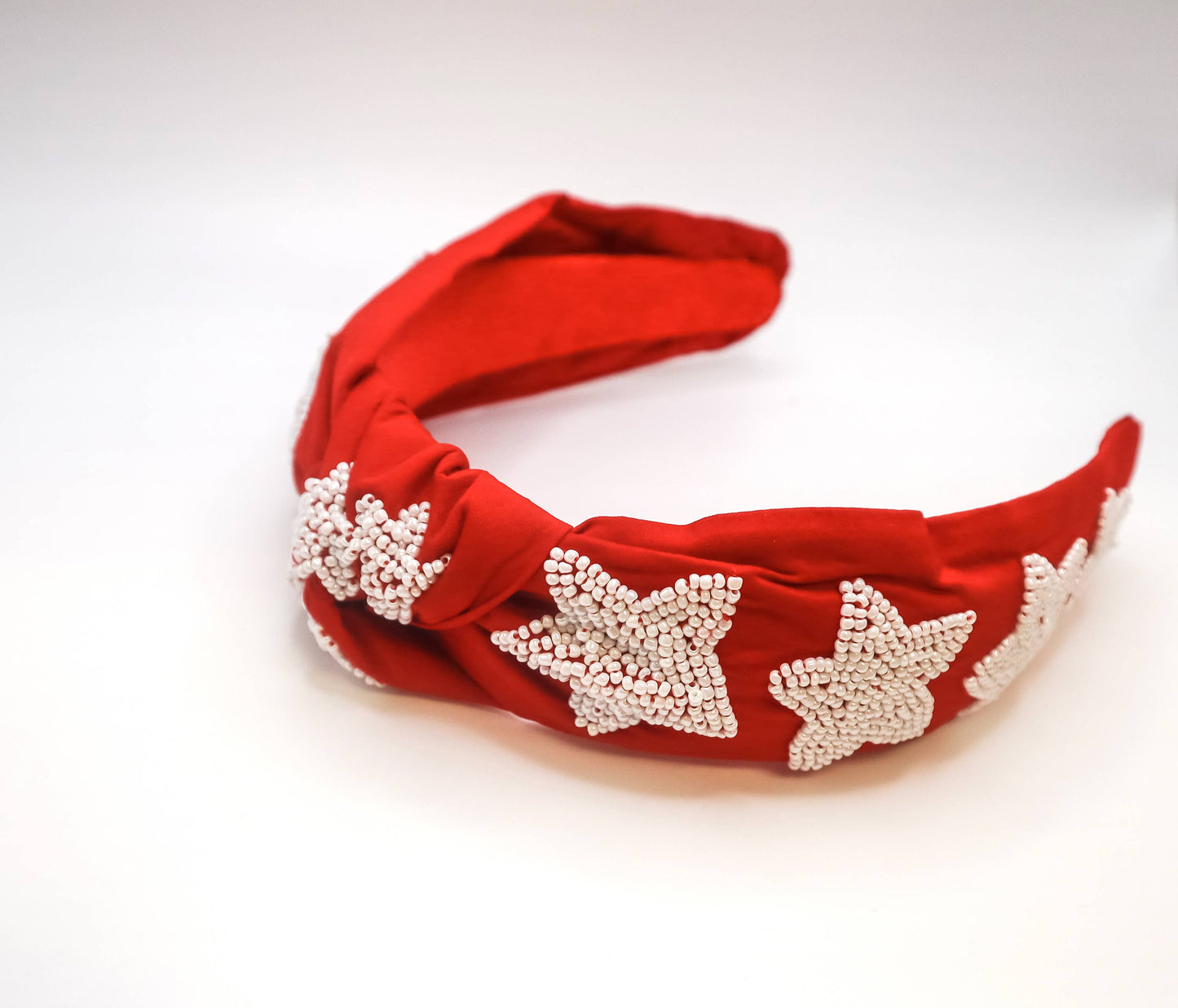 A Bash New Orleans Football Headband with Black and Gold Stars on a red background.