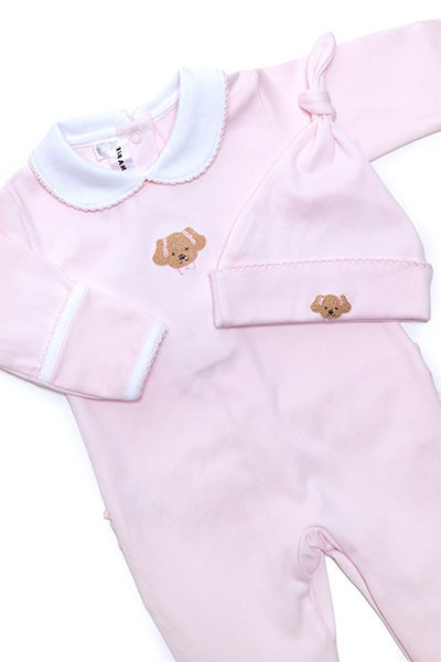 A Milly Marie pink baby outfit with a Milly Marie Pima Knot Hat and a Girl Puppy teddy bear on it.