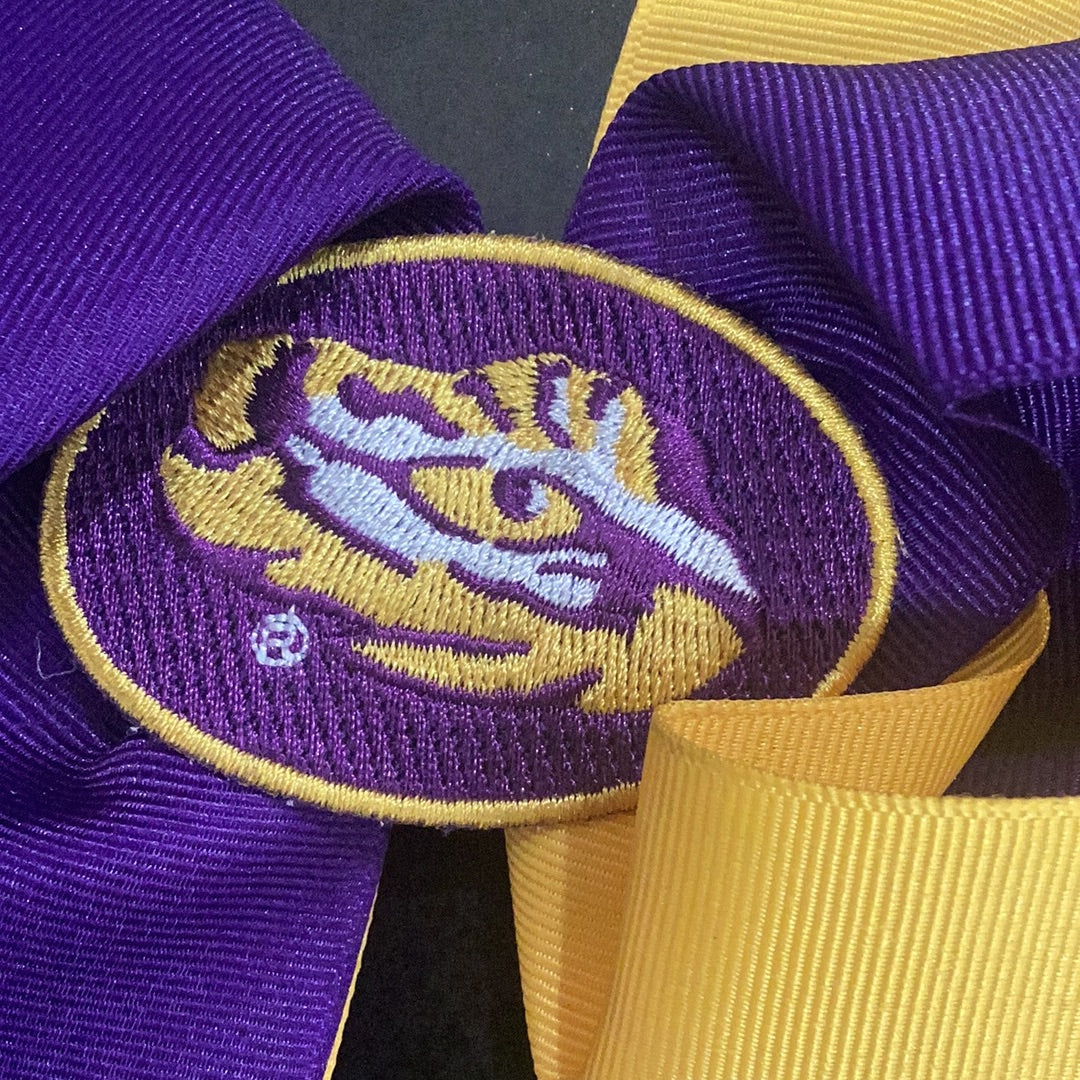 Large Wee Ones LSU bow with embroidered eye of the tiger in the middle and no-slip clip.
