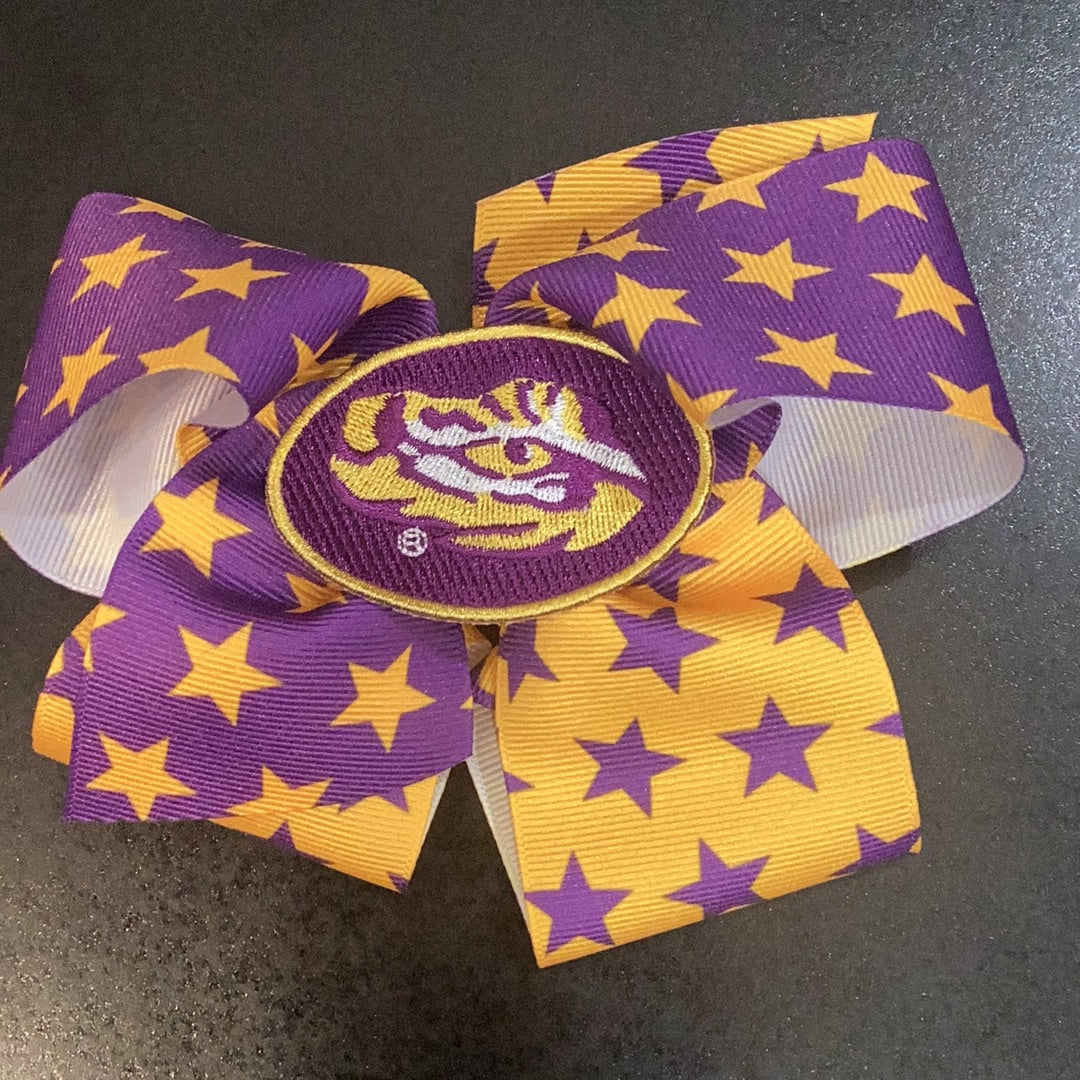 Wee Ones LSU Stars bow featuring an embroidered Eye of the Tiger design and a no-slip clip.