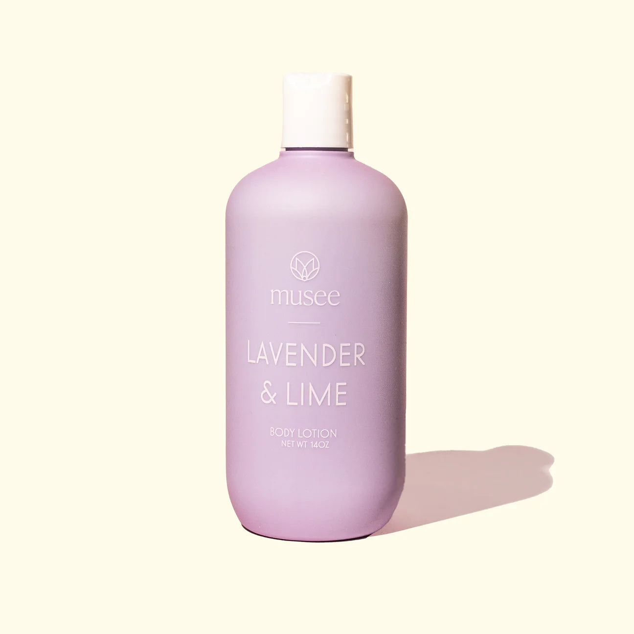 Description: A bottle of Musee Lavender+Lime Body Lotion on a white background.