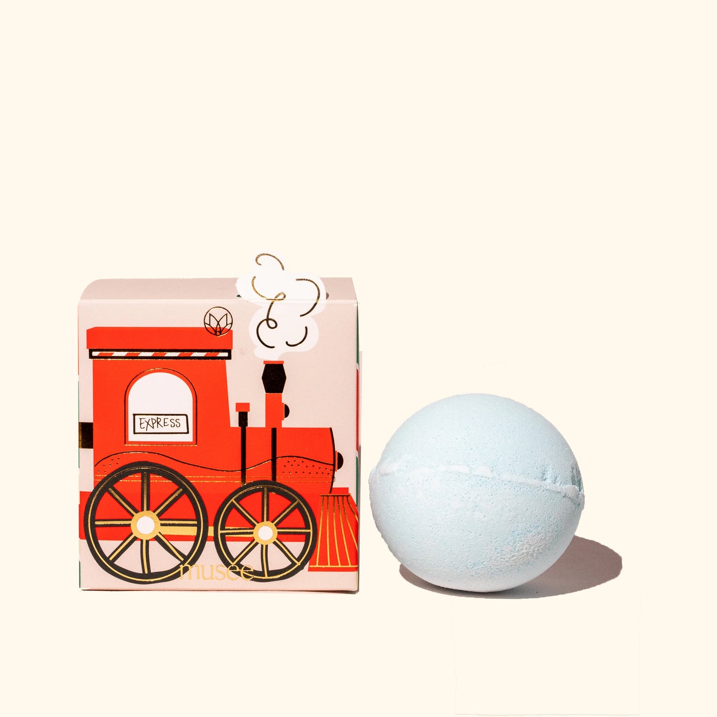 A Musee Train Bath Balm with a train on it next to a box, made with high-quality ingredients.
